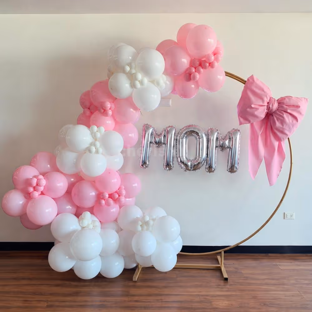 An arch with white and pink multi-sized and textured balloons captures the joy of Mother's Day