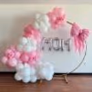 An arch with white and pink multi-sized and textured balloons captures the joy of Mother's Day