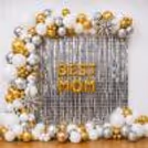 The Silver Square Frill Curtain Backdrop With Chrome Balloon Arch Makes The Glamorous Setup