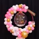 The Sturdy, Round Ring Stand With Pink Ribbon Holds Every Element Firmly.