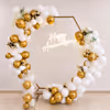 CherishX anniversary decor with premium gold and white balloons, floral accents, and glowing Happy Anniversary neon.