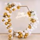CherishX anniversary decor with premium gold and white balloons, floral accents, and glowing Happy Anniversary neon.