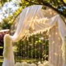 Experience the magic of our heartwarming ring floral backdrop adorned in warm-glowy pixel lights.