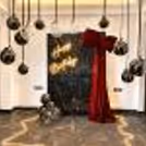Black macron and bubble balloons with ribbons and bows resemble hanging stars.
