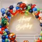 Foil Avenger-Shaped Balloons On The Ring Stand Add More Drama To The Balloon Decoration.