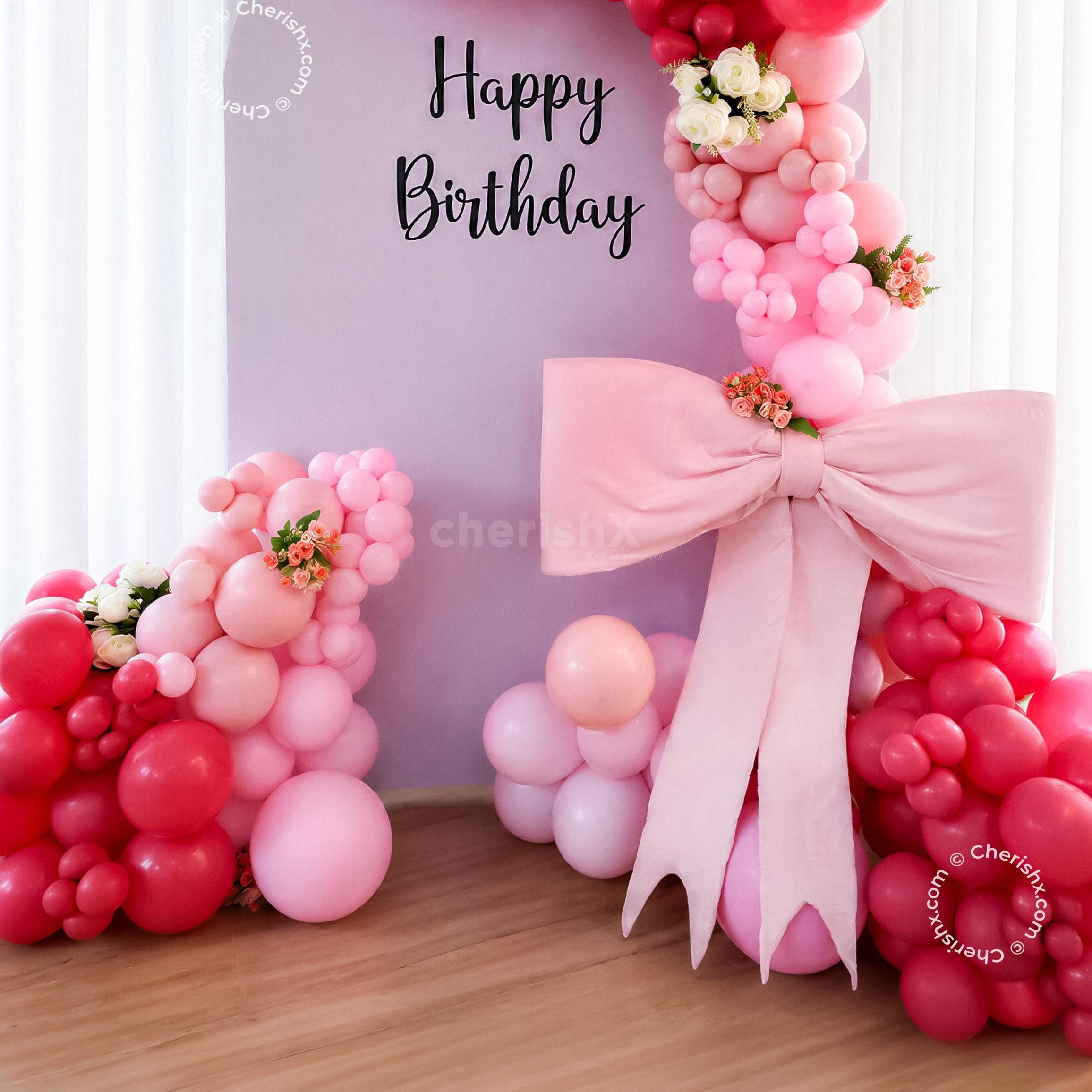 A sunboard cutout on the stand makes the perfect frame for the backdrop and balloon arch.