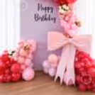 A sunboard cutout on the stand makes the perfect frame for the backdrop and balloon arch.