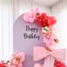 Pink macron balloons add texture to the balloon arrangement and top up the look.
