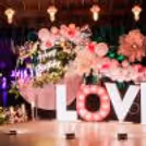 The grand ring stand with a custom sunboard cutout is well decorated with a fabric floral cluster.