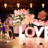 Flowers and leaves arranged on a ring stand add organic greenery to the backdrop.