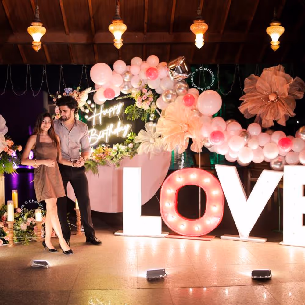 Flowers and leaves arranged on a ring stand add organic greenery to the backdrop.