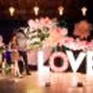 Flowers and leaves arranged on a ring stand add organic greenery to the backdrop.