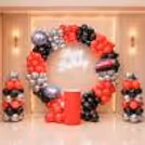 A Large Arch Of Balloons In The Bright Colours On The Ring Stand Pointing Out Birthday Car Race Fun.