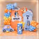 Soft pastel balloons and Bluey style cutouts created a fun birthday backdrop.
