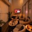 A Private Lounge Setup Enhances The Romance With Candle And Rose Petals Decoration.