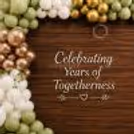Several green, white and metallic gold balloons are shown around a wooden anniversary background with foliage decorations.