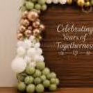 A natural touch in the vintage anniversary backdrop with green artificial vine leaves woven into the balloon arrangement.