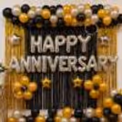 Black and gold frill curtains were used as the backdrop around the anniversary display.