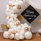 Balloon theme background with white balloons, flowers and candles for an anniversary celebration.