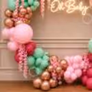Soft pinks and greens craft a baby shower full of warmth and wonder