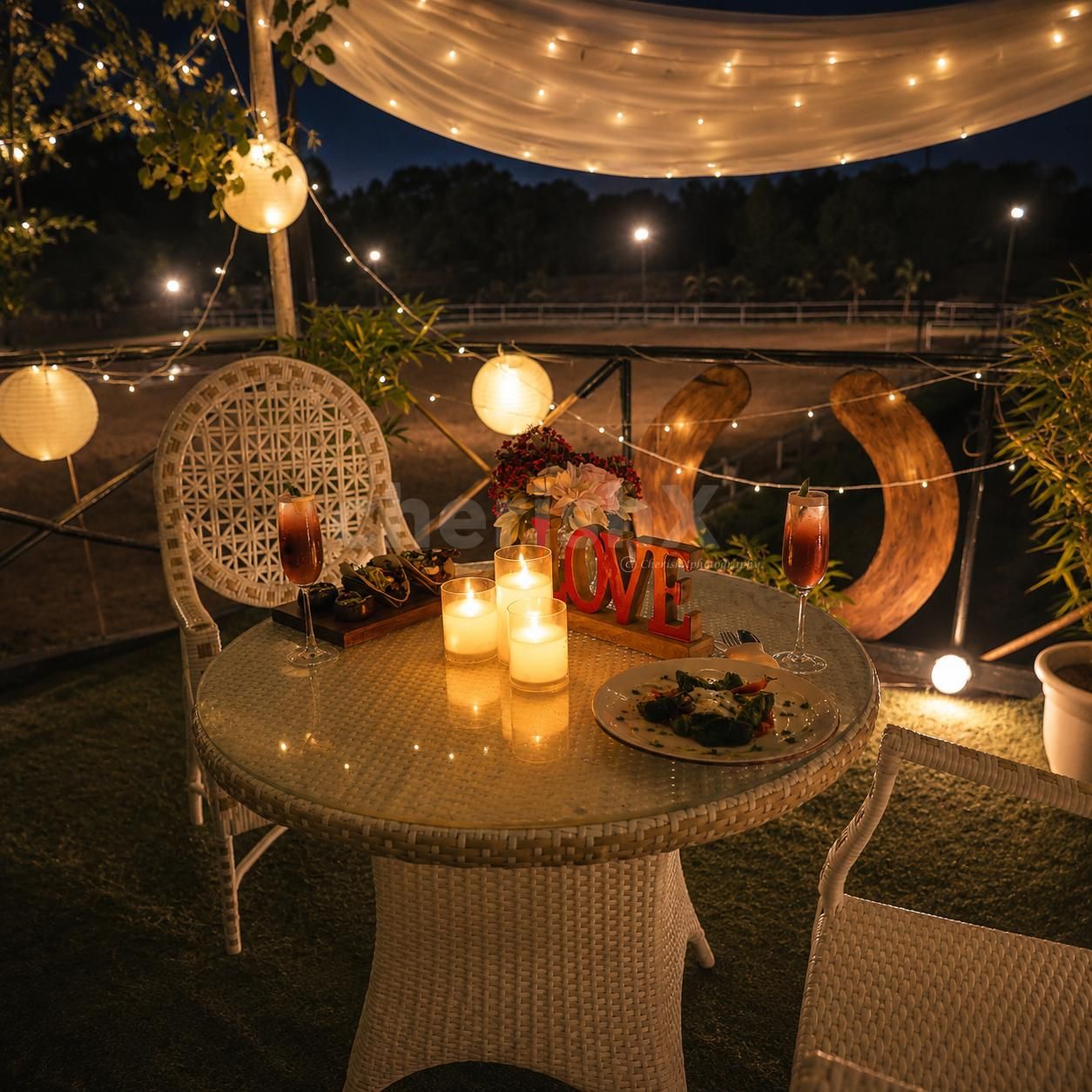 Make your evening unforgettable with CherishX’s open-air candlelight dining experience near a horse stable.