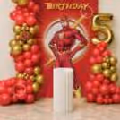 Colourful Birthday Corner With Red And Gold Cascading Clusters And A Metallic Age Foil Balloon.
