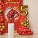 A “Happy Birthday” Display With A Classy Balloon Garland And Superhero-Inspired Touches.