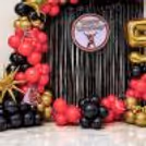 Golden Number 5 Balloon Standing Next To Balloon Decorations for a birthday party.