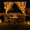 Enjoy a romantic candlelight dinner by CherishX, set in a dreamy open-air horse stable with fairy lights, flowers, and a luxury private dining setup