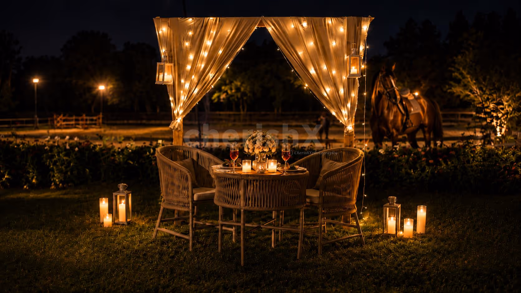 Enjoy a romantic candlelight dinner by CherishX, set in a dreamy open-air horse stable with fairy lights, flowers, and a luxury private dining setup