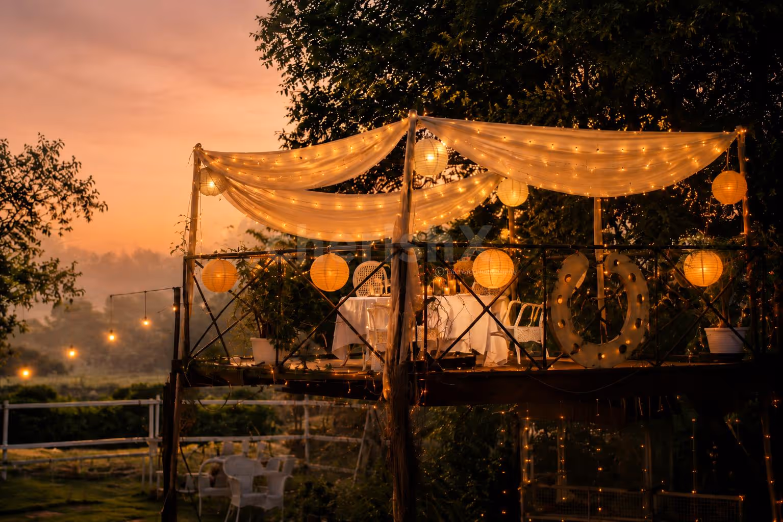 A dreamy CherishX candlelight dinner on a beautiful machan, surrounded by fairy lights, horses, and open-air romance