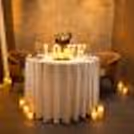 A private candlelight dinner by CherishX, designed with glowing candles, rose petals, and a romantic LOVE table setup for an unforgettable date night.