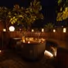 A beautiful table for a candlelight dinner with flowers, lit candles and elegant table settings.