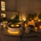 Romantic zen garden candlelight dinner setup with beautifully decorated table and glowing candles.