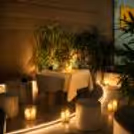 Flowers, candles and a happy garden atmosphere on an elegant dinner table for a candlelight dinner.