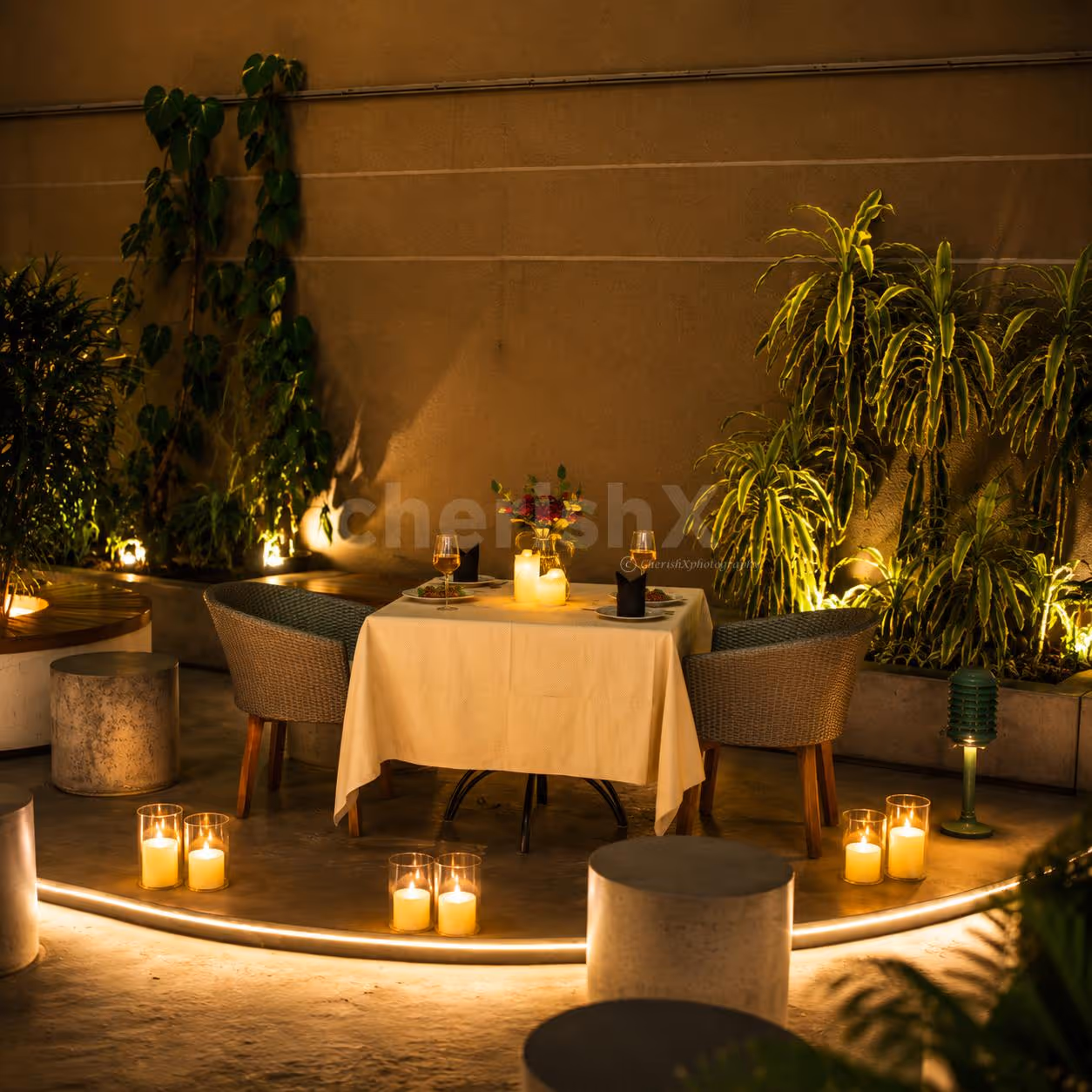 Intimate outdoor dinner table surrounded by candles and modern décor in Gurugram