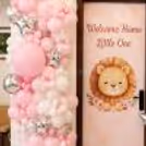Customised Baby Girl Banner With Lion Graphic And Pink Decor Background.