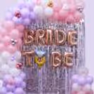 Silver fringe party curtain, ring foil balloon and pastel balloon backdrop for the bachelorette party.