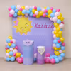 Pastel balloon entryway in bright sunshine theme.