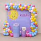 Pastel balloon entryway in bright sunshine theme.