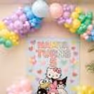 Pastel Balloon Arch Hello Kitty Theme Background For A Child's Birthday Party.