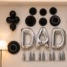 Father's Day decoration with hanging tassels and minimal wall setup, black and silver decor.