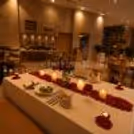 Romantic candlelight dinner setup with rose petals and elegant table décor at a luxury hotel restaurant