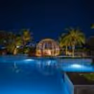 Private couple dining experience beside a beautifully illuminated swimming pool.
