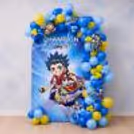 Dark Blue, Yellow And Pastel Blue Balloon Arch With Beyblade Themed Wall Banner.