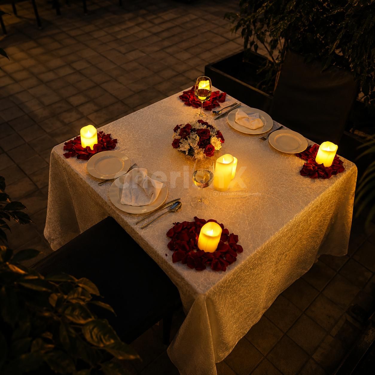 Luxury outdoor dining experience designed with warm lighting, floral arrangements, and sophisticated tablescape styling.
