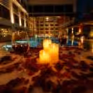 Close-up of a beautiful table with candles, rose petals and a fine dining setting.