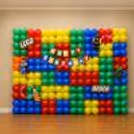 Big Lego Logo On A Wall Made From Red, Blue, Green And Yellow Balloons.
