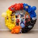 Beyblade Wall With Colourful Balloon Arch And Anime Art Panels.