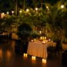 Candle decor and comfortable seating for a private dining alfresco area.